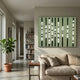 Strata Olive LED Wall Art by Giant Sculptures displayed above a beige sofa in a modern living room with a fiddle-leaf fig, bookshelf, and hallway view.