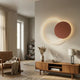 Soluna Copper Acrylic 3D LED Wall Art by Giant Sculptures displayed above a wooden sideboard in a living room, glowing ring overlapping a copper disc.