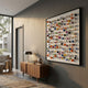 Aeris Multi-Coloured Wooden Sphere 3D Wall Art by Giant Sculptures displayed in a modern hallway above a walnut sideboard with lamp and books.