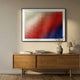 Elytrum Red & Blue Grid Gradient Hand-Painted Wood Relief 3D Wall Art in black frame, displayed above an oak sideboard with vase and lamp in a hallway.