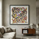 Aeris Multi-Coloured Wooden Disc 3D Wall Art by Giant Sculptures in a black frame, displayed above a wooden sideboard in a neutral living room.