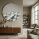 Solivis Frost White Round 3D Wood Relief Wall Art mounted above a walnut sideboard with pampas grass, beside a bookshelf and linen sofa in a neutral living room.