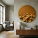 Solivis Bronze Round 3D Wood Relief Wall Art by Giant Sculptures mounted on a pale wall above a walnut sideboard, beside a grey armchair and window.