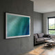 Elytrum Blue Grid Gradient Hand-Painted Wood Relief 3D Wall Art by Giant Sculptures, framed in black on a grey wall above a grey sofa in a modern living room.