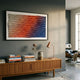 Elytrum Red & Blue Gradient Hand-Painted Wood Relief 3D Wall Art by Giant Sculptures above a teak sideboard with books, vase, and copper lamp.