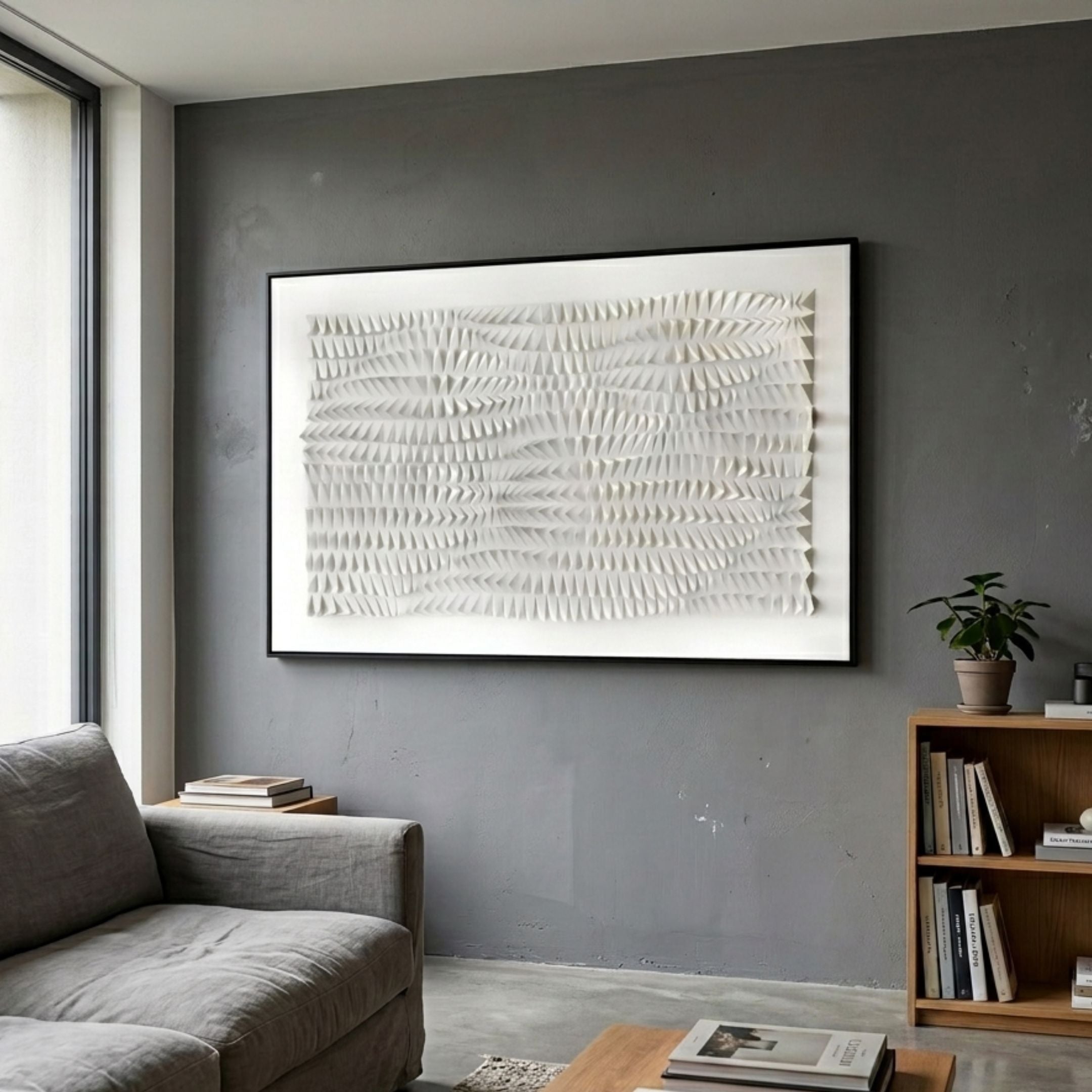 Elytrum White Hand-Painted Wood Relief 3D Wall Art by Giant Sculptures, framed in black above a grey sofa in a modern living room with a wooden bookshelf.