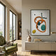 Vitrus Orange & Green Abstract Wood Embossed 3D Wall Art by Giant Sculptures displayed above a cream sideboard in a modern living room with a green armchair.