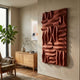 Ombra Burgundy Hand-Painted 3D Wood Relief Wall Art by Giant Sculptures mounted in a living room above an oak sideboard beside a fiddle-leaf fig and armchair.