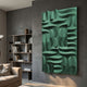 Ombra Green Hand-Painted 3D Wood Relief Wall Art by Giant Sculptures mounted on a grey wall in a modern living room beside a bookshelf and beige sofa.