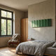 Vireus Green Single Panel 3D Wood Relief Wall Art by Giant Sculptures mounted above a linen-dressed bed in a bedroom with oak wardrobe and armchair.