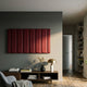 Vireus Burgundy Rectangular 3D Wood Relief Wall Panel by Giant Sculptures mounted above a walnut console with books, vase, and brass lamp in a living room.