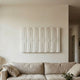 Vireus White Rectangular 3D Wood Relief Wall Panel by Giant Sculptures mounted above a linen sofa in a minimalist living room with pale walls.