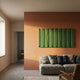 Vireus Forest Green Rectangular 3D Wood Relief Wall Panel by Giant Sculptures mounted on a terracotta wall above a linen sofa in a modern living room.