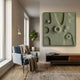 Terravura Square Olive Green II 3D Wood Relief Wall Art displayed in a modern living room above a walnut console beside a blue armchair and floor lamp.