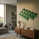 Axura Green Geometric Wood Relief 3D Wall Art mounted above a walnut sideboard in a modern living room with a grey sofa and ceramic shelf display.