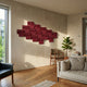 Axura Red Geometric Wood Relief 3D Wall Art mounted on a cream wall in a living room with wooden floors, beige sofa, midcentury chair, and fiddle leaf fig.