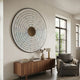 Solis Radiant Brown Core Wood Relief 3D Wall Art by Giant Sculptures mounted above a walnut sideboard in a living room with a grey armchair and window.