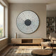 Solis Radiant Grey Core Wood Relief 3D Wall Art by Giant Sculptures, a circular grey tile mosaic mounted above a light wood console in a modern living room.