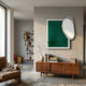 Reflectra Green Wood Relief 3D Wall Art by Giant Sculptures mounted above a walnut sideboard in a modern living room with leather chair and bookshelf.