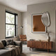 Reflectra Brown Wood Relief 3D Wall Art with Silver Mirror by Giant Sculptures displayed above a walnut sideboard in a modern living room with a leather chair.