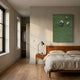Verdara Green Wood Relief 3D Wall Art by Giant Sculptures mounted above a walnut bed with linen bedding, nightstand and lamp in a sunlit bedroom.