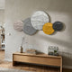 Orbita 5-Set Circular Grey & Gold 3D Wood Relief Wall Art by Giant Sculptures displayed above an oak console with books and vase in a modern hallway.