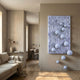 Fluxion Lavender 3D Wood Relief Wall Art by Giant Sculptures displayed in a neutral living room, with glossy lavender spheres cascading from the carved panel onto the floor.