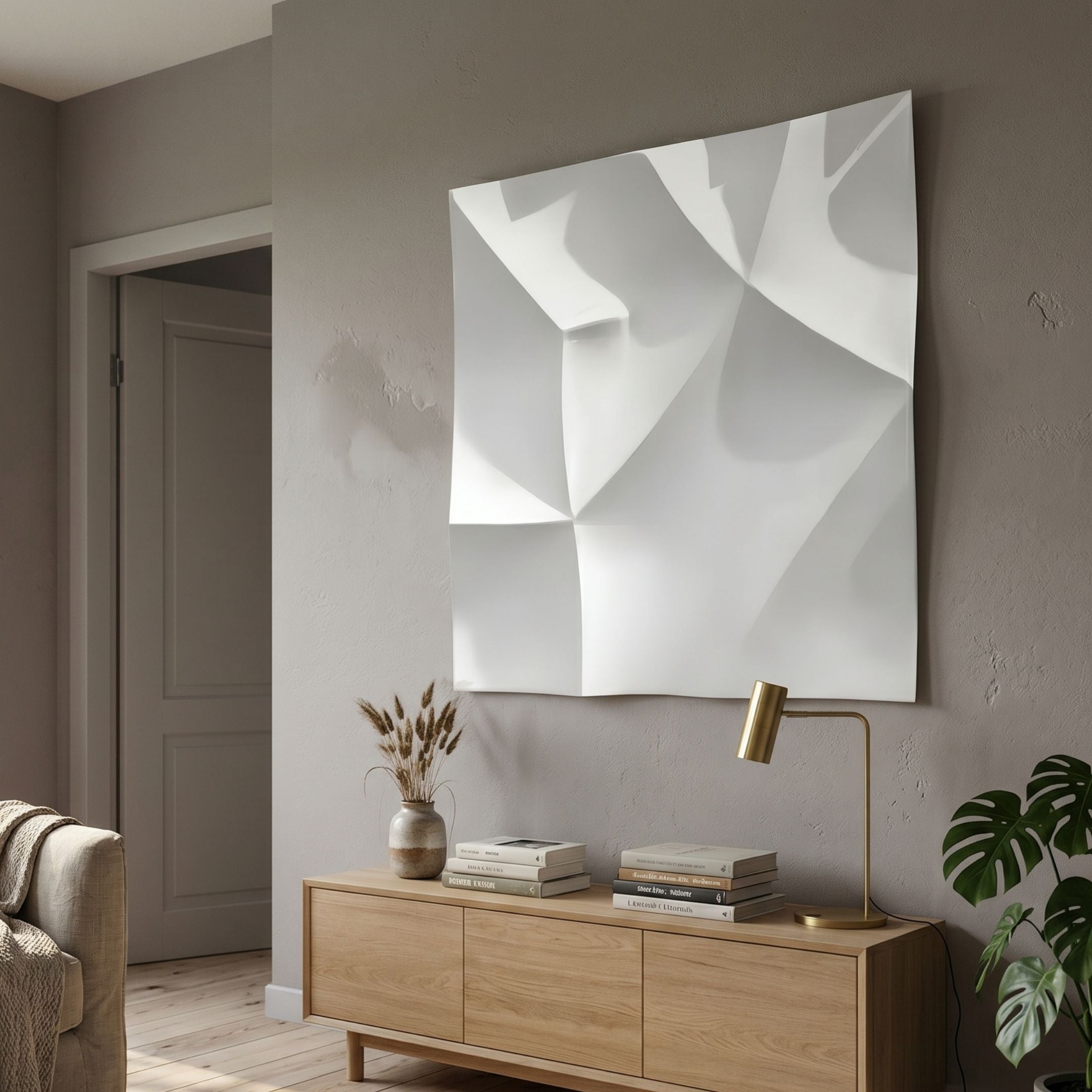 Tessara III White 3D Wood Relief Wall Art by Giant Sculptures displayed above an oak sideboard with a brass lamp, vase of dried grasses, and monstera plant.