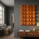Ondula Textured Orange Wood Relief 3D Wall Art by Giant Sculptures mounted on a dark grey wall above a walnut console in a modern living room.