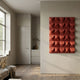 Ondula Textured Red Wood Relief 3D Wall Art by Giant Sculptures mounted on a beige wall in a minimalist living space with wood flooring and a kitchen nook.