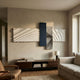 Axentra Midnight Blue & White Geometric Wood Relief 3D Wall Art by Giant Sculptures displayed above a dark wood console in a warm neutral living room.