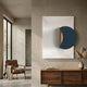 Solvara Midnight Blue & White Wood Relief 3D Wall Art displayed above a walnut sideboard with pampas grass, beside a leather armchair in a minimalist room.