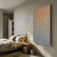 Spectrum Weave Vertical Earthy Ombre Wood Relief 3D Wall Art mounted in a modern bedroom above a wooden nightstand beside a linen bed and brass lamp.