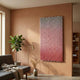 Spectrum Weave Vertical Rose Blush Wood Relief 3D Wall Art by Giant Sculptures displayed on a terracotta wall above a grey sofa, fiddle leaf fig, and brass floor lamp.