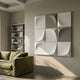 Curvatura White & Olive 3D Wood Relief Wall Art by Giant Sculptures mounted on a beige wall above an olive sofa beside a white bookshelf in a modern living room.