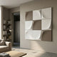 Curvatura White & Grey Grid 3D Wood Relief Wall Art by Giant Sculptures mounted in a modern living room beside a bookshelf, floor lamp, and beige sofa.