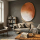Fluctus Orange Textured Sandstone Wood Relief 3D Wall Art by Giant Sculptures mounted above a grey sofa in a Nordic living room with bookshelf and wood coffee table.
