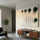 Galactica White Wood Relief 3D Wall Art by Giant Sculptures, with five green metal spheres on a carved rippled panel, displayed above a walnut sideboard.