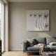 Galactica White Wood Relief 3D Wall Art by Giant Sculptures displayed above a grey sofa with linen throws in a minimalist Nordic living room.