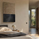 Artura Beige & Black Hand-Painted 3D Relief Wall Art by Giant Sculptures displayed above a bedside table with dome lamp in a sunlit cream-walled bedroom.
