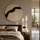 Artura Ivory Round Hand-Painted 3D Relief Wall Art by Giant Sculptures mounted above an upholstered bed with linen bedding and a walnut nightstand.