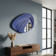 Reflecta Blue Wood Carving Mirror 3D Wall Art by Giant Sculptures, layered curved blue panels with a central mirrored aperture, mounted above a walnut console.