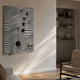 Calidora Wave Sculpted Textured 3D Relief Wall Art by Giant Sculptures, silver wavy ridges with black and chrome spheres, mounted in a sunlit living room.