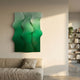 Mystique Green Fabric Abstract Wood Relief 3D Wall Art by Giant Sculptures, three wavy ombre green panels mounted above a linen sofa in a sunlit living room.