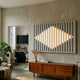 Verlux Geometric Glow 3D LED Wall Art by Giant Sculptures mounted above a teak sideboard in a living room, with vertical black slits and a glowing diamond LED cluster.