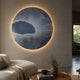 Earthlight Emerald Cascade 3D Textured Oil Painting LED Wall Art by Giant Sculptures, circular grey piece with white wireframe mesh, backlit above a beige sofa.