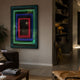 Vitralis Colorwave 3D Mirror LED Wall Art by Giant Sculptures with green, blue, and red neon rectangles in a modern living room beside a bookshelf.