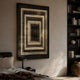 Vitralis Urban Mirage 3D Mirror LED Wall Art by Giant Sculptures, with white LED concentric squares creating an infinity tunnel, mounted above a bedroom nightstand.