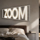 Aurova III Industrial Glow 3D LED Wall Art by Giant Sculptures, illuminated ZOOM lettering behind grey horizontal slats, mounted above a brown leather bed.