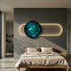 Vitreon 3D Deep Teal Crystal Porcelain Wall Art by Giant Sculptures mounted above a wooden bed, with a marbled teal disc set in an illuminated gold oval frame.